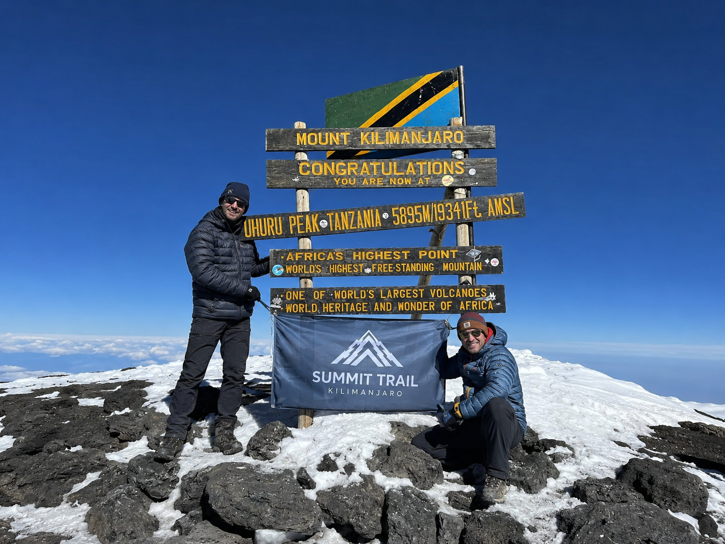 Trekking operator: team at a recognizable landmark. No vehicle needed when the location does the work.